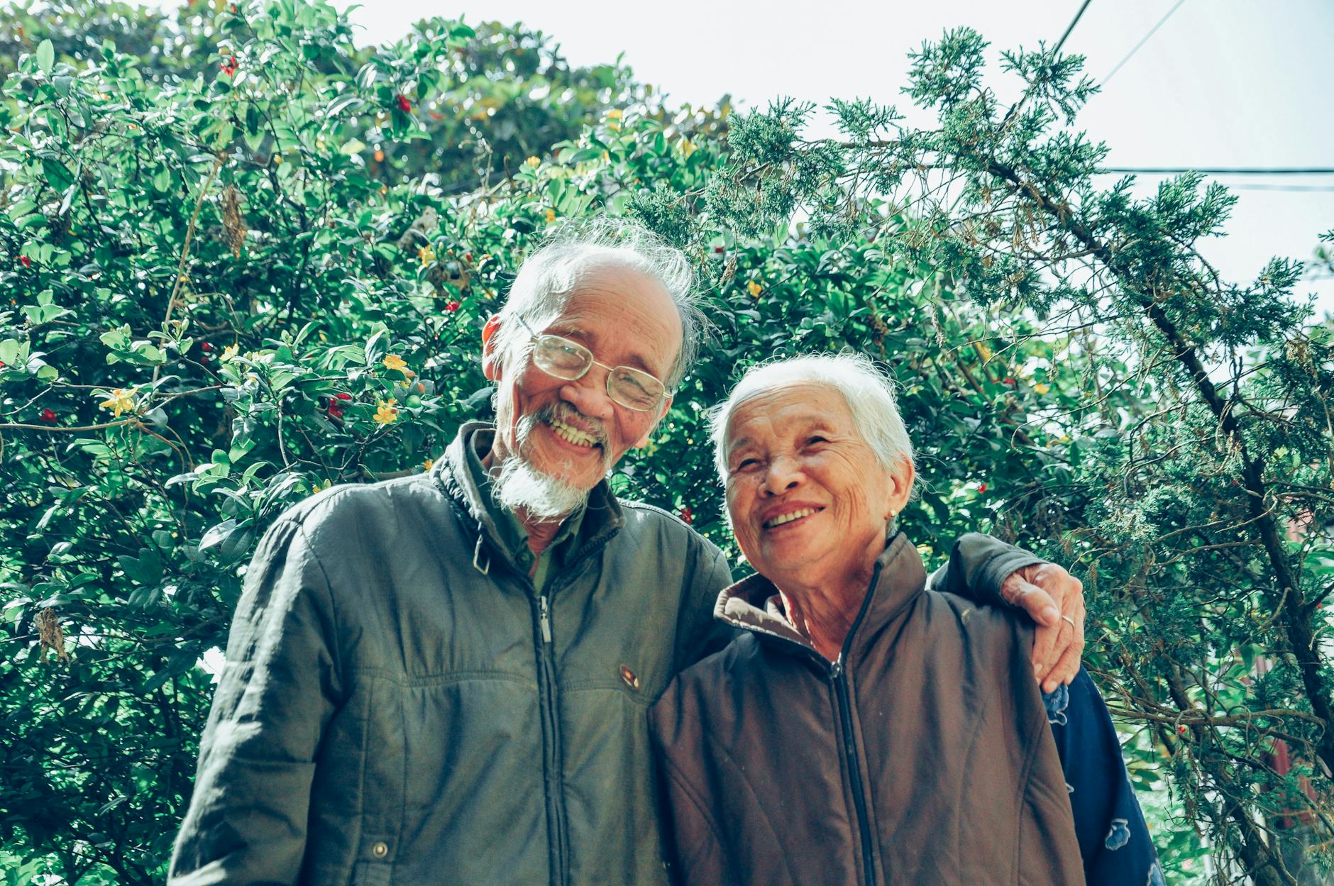 smiling man and woman wearing jackets